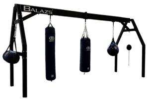 Balazs Large A-Frame heavy bag stand installed in an athletic training room with two bags
