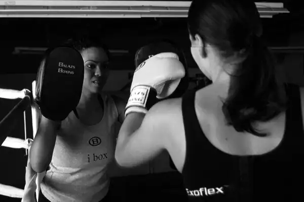 female trainer and female fighter practicing