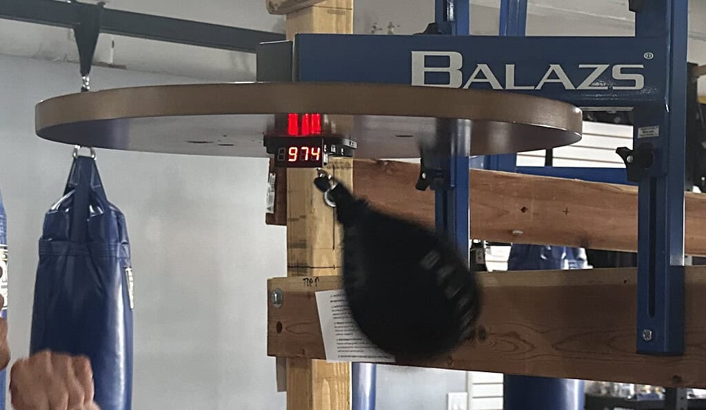 Balazs speed bag platform with a digital rep counter reading 974 and the bag in motion