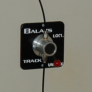 Balazs wall-mounted lock and track control switch beside an Ultra-Trak installation