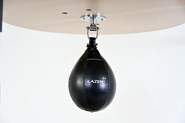 Black Balazs Lazer 10 x 7 inch medium speed bag, Lazer-logo view, mounted beneath a wooden platform