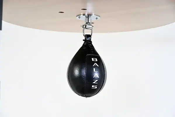 Black Balazs Lazer 9 x 6 inch small speed bag, Balazs-logo view, mounted beneath a wooden platform