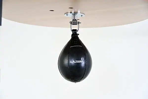Black Balazs Lazer 9 x 6 inch small speed bag, Lazer-logo view, mounted beneath a wooden platform